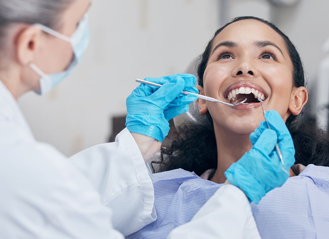 Employee Benefits - Woman Having a Dental Checkup in an Office